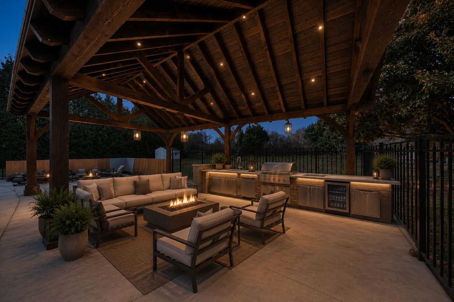 Timber pavilion at dusk with an outdoor kitchen