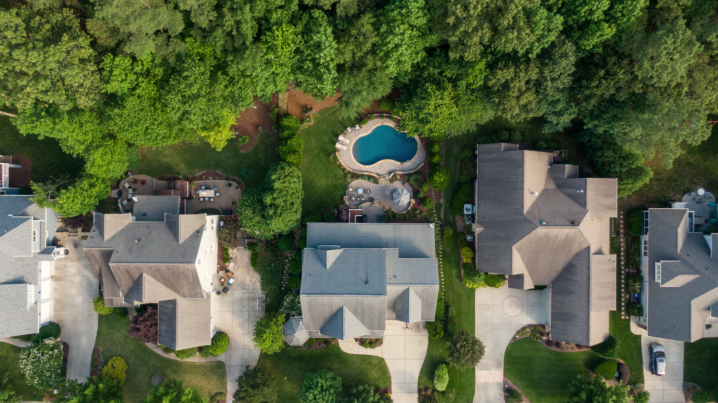 Shingle hip roofs on suburban houses, seen from above